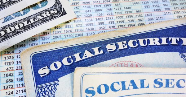 Social Security cards with cash and benefit amount numbers